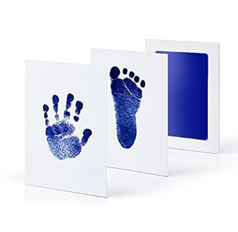 Blue hand and footprints on white cards with a blue ink pad.
