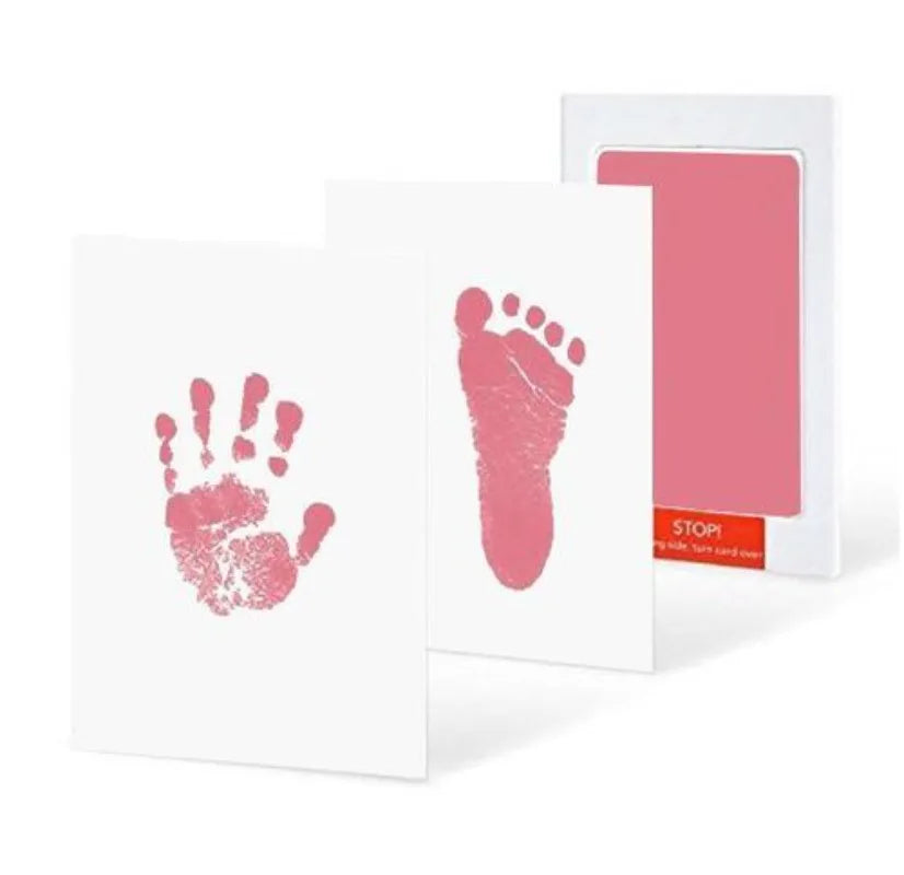 Baby hand and foot print kit with pink ink pads on a white background