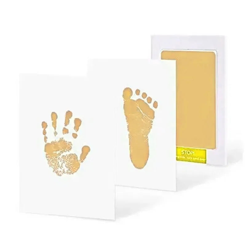 Gold hand and foot print kit with a card on a white background